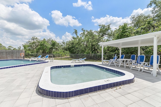32801 US Highway 441 N Unit 64, Okeechobee, FL 34972 - community pool featuring fence, a patio area, and view of wooded area