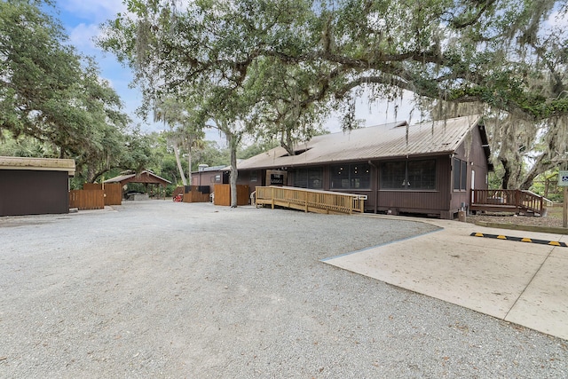 32801 US Highway 441 N Unit 64, Okeechobee, FL 34972 - rear view of house with a deck and metal roof
