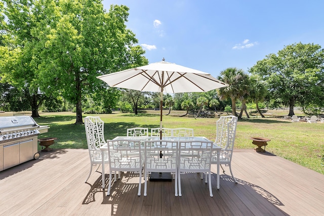 32801 US Highway 441 N Unit 64, Okeechobee, FL 34972 - wooden terrace featuring outdoor dining space, a yard, area for grilling, and view of wooded area