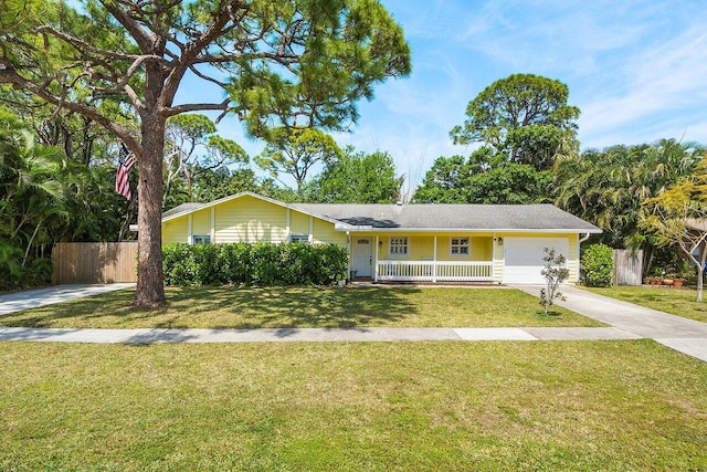 903 Oak Cir, Jupiter, FL 33458 - ranch-style house with concrete driveway, an attached garage, and covered porch