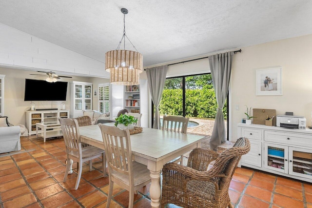 903 Oak Cir, Jupiter, FL 33458 - dining space featuring a textured ceiling, ceiling fan, a chandelier, vaulted ceiling, and light tile patterned floors