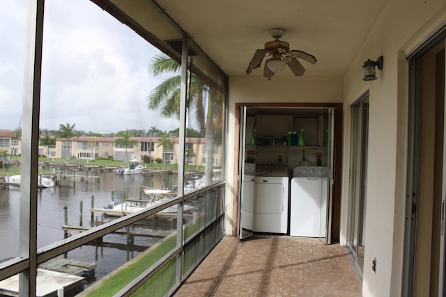 unfurnished sunroom with washing machine and dryer and a water view