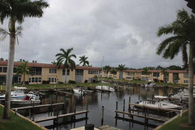 dock area with a water view and boat lift