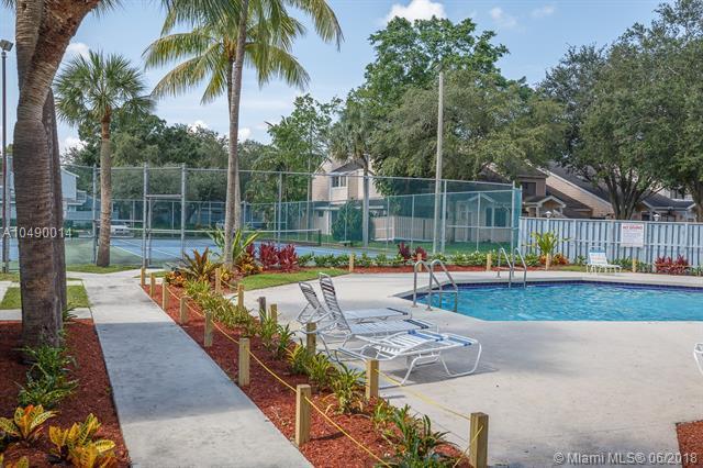 2167 Champions Way N, Lauderdale, FL 33068 - community pool with fence, a tennis court, and a patio area