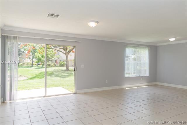2167 Champions Way N, Lauderdale, FL 33068 - unfurnished room with ornamental molding, light tile patterned flooring, and baseboards