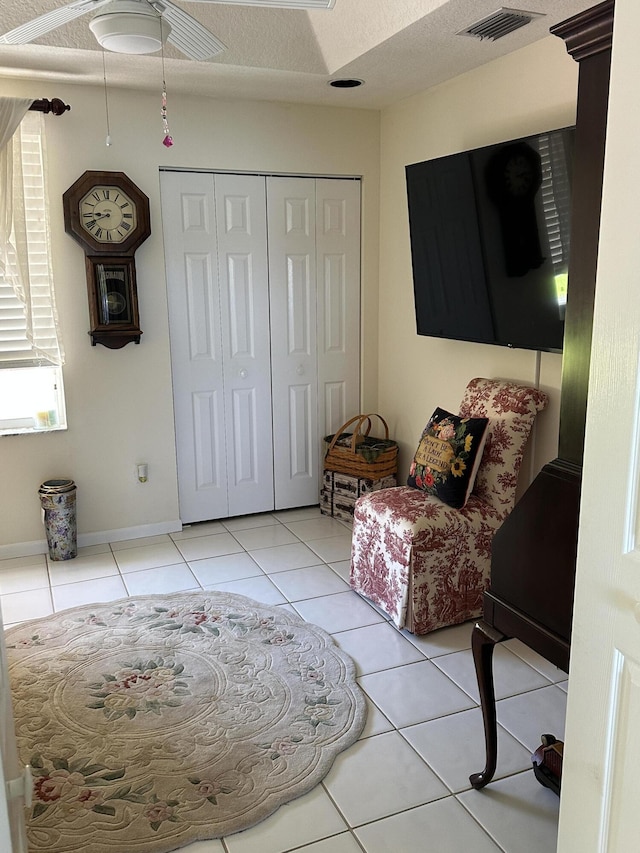 17287 Boca Club 1 Blvd Unit 1, Boca Raton, FL 33487 - living area featuring light tile patterned floors and a textured ceiling