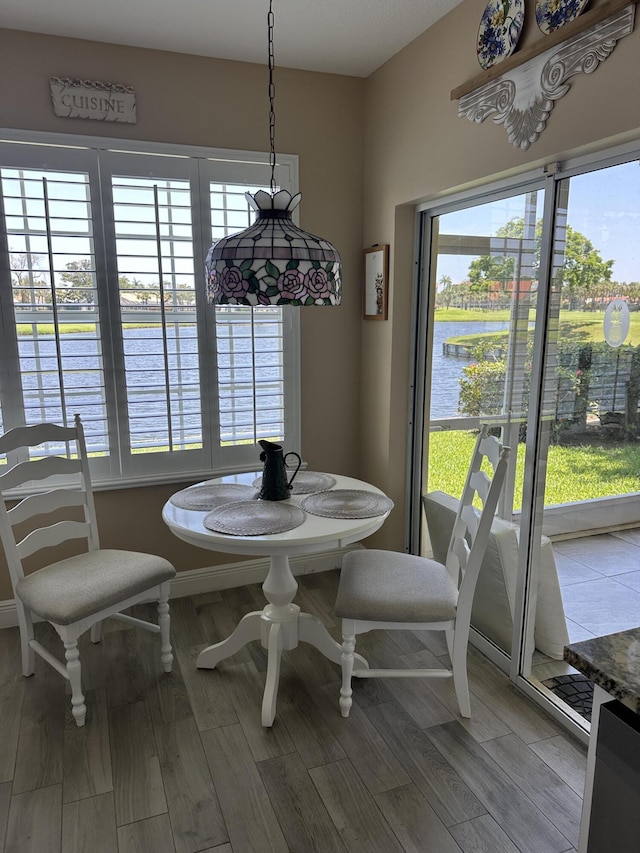 17287 Boca Club 1 Blvd Unit 1, Boca Raton, FL 33487 - dining area featuring a water view and wood finished floors