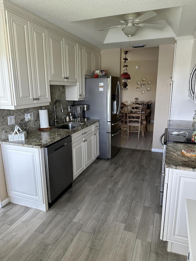 17287 Boca Club 1 Blvd Unit 1, Boca Raton, FL 33487 - kitchen with stainless steel appliances, a sink, light wood-style floors, tasteful backsplash, and a ceiling fan