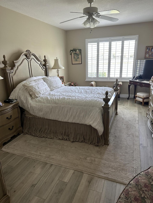 17287 Boca Club 1 Blvd Unit 1, Boca Raton, FL 33487 - bedroom with light wood finished floors, a textured ceiling, and a ceiling fan