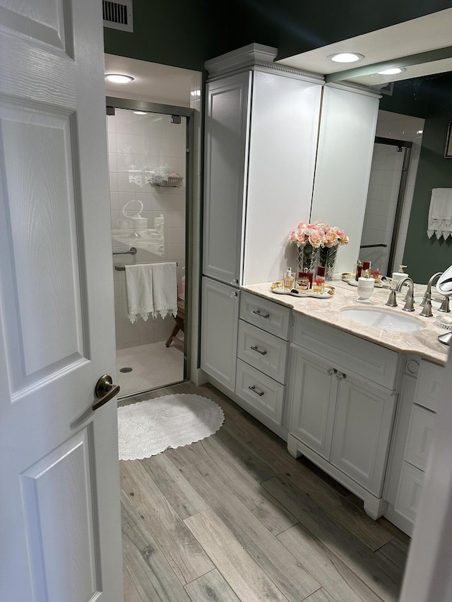 17287 Boca Club 1 Blvd Unit 1, Boca Raton, FL 33487 - bathroom with a shower stall, vanity, and wood finished floors