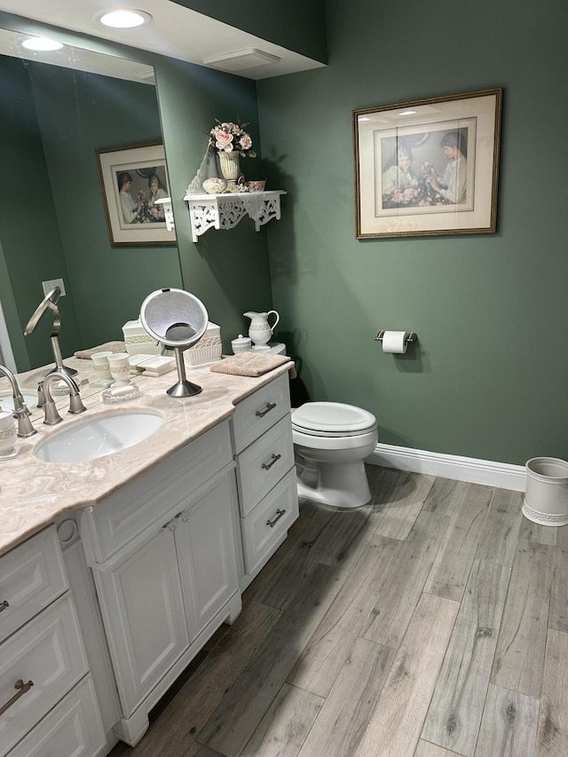 17287 Boca Club 1 Blvd Unit 1, Boca Raton, FL 33487 - bathroom with vanity, wood finished floors, toilet, and baseboards