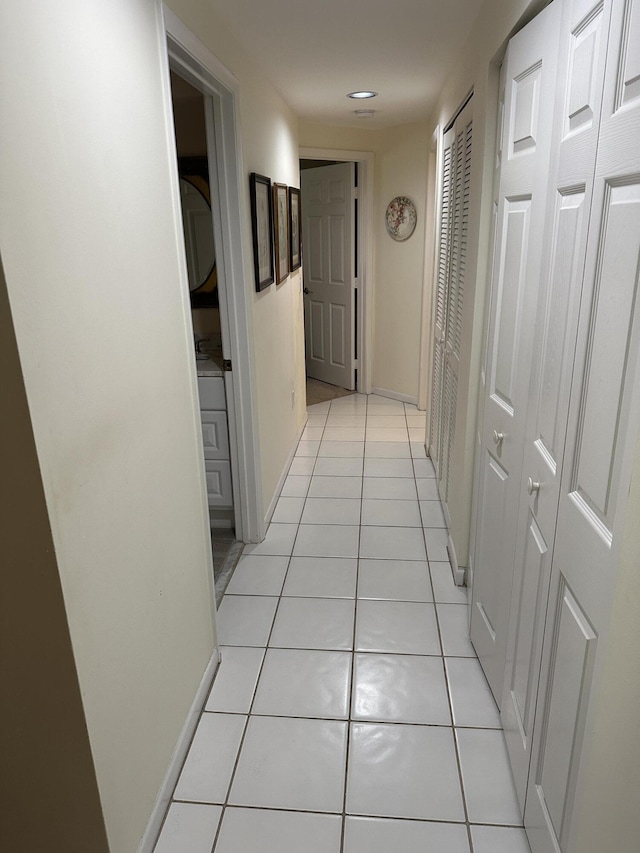 17287 Boca Club 1 Blvd Unit 1, Boca Raton, FL 33487 - corridor featuring light tile patterned flooring, recessed lighting, and baseboards