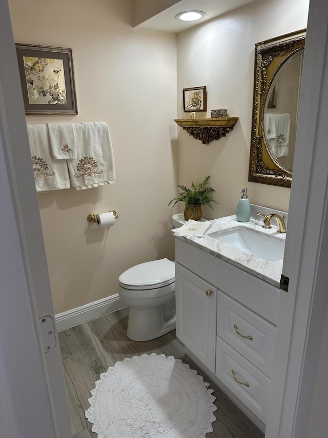 17287 Boca Club 1 Blvd Unit 1, Boca Raton, FL 33487 - bathroom featuring vanity, toilet, wood finished floors, and baseboards