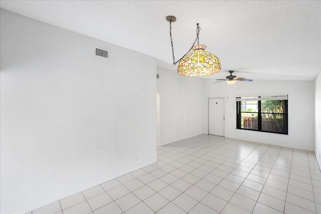 unfurnished room with a ceiling fan, light tile patterned flooring, and a textured ceiling