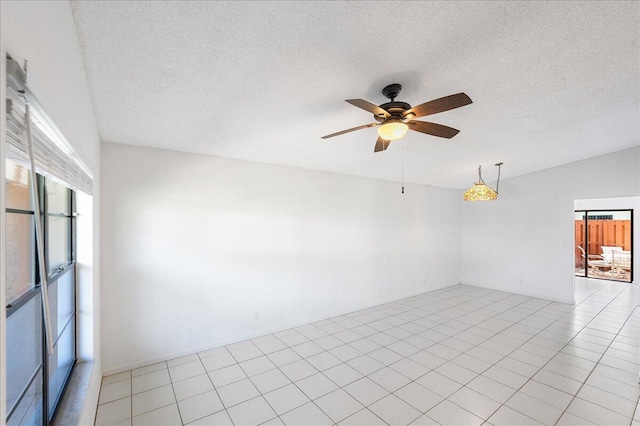 unfurnished room with ceiling fan and a textured ceiling