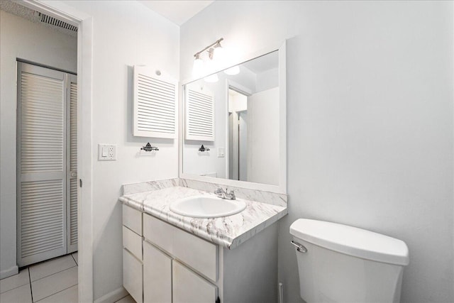 bathroom featuring toilet, vanity, and tile patterned floors