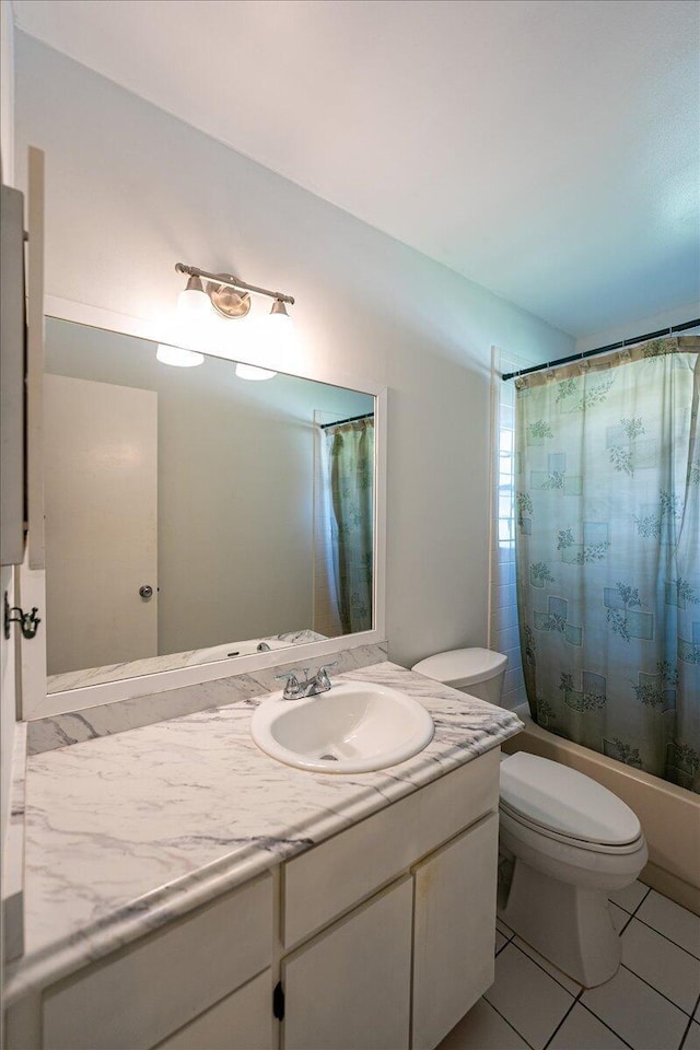 full bathroom featuring toilet, vanity, shower / tub combo with curtain, and tile patterned floors