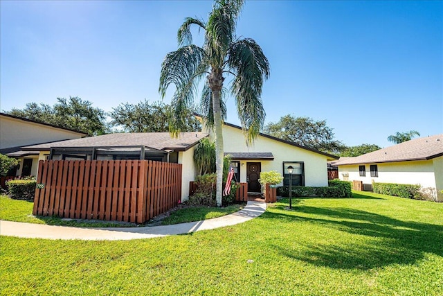 view of front of home with a front lawn and stucco siding