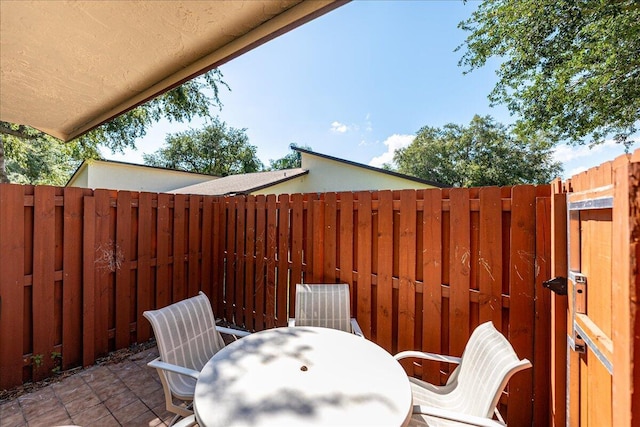 view of patio / terrace featuring fence and outdoor dining space
