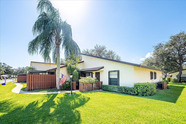 view of front of home featuring stucco siding and central AC unit