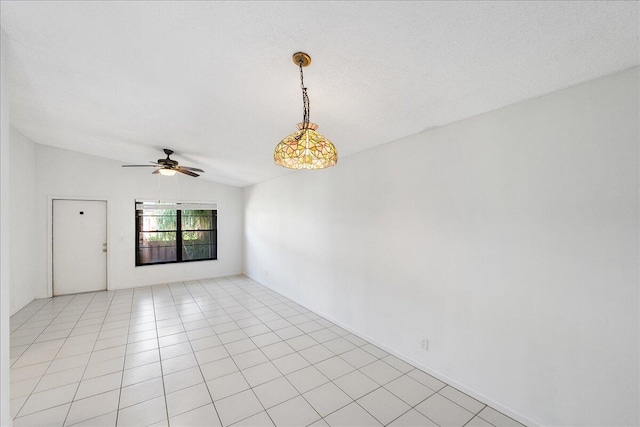 unfurnished room with ceiling fan, lofted ceiling, and light tile patterned floors