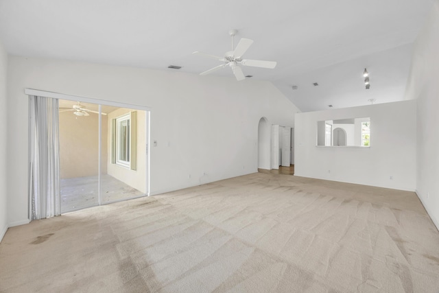 unfurnished room featuring lofted ceiling, a ceiling fan, and carpet flooring