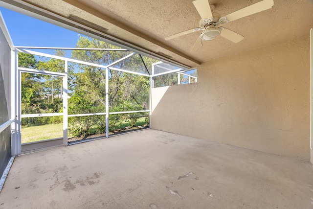 unfurnished sunroom featuring ceiling fan