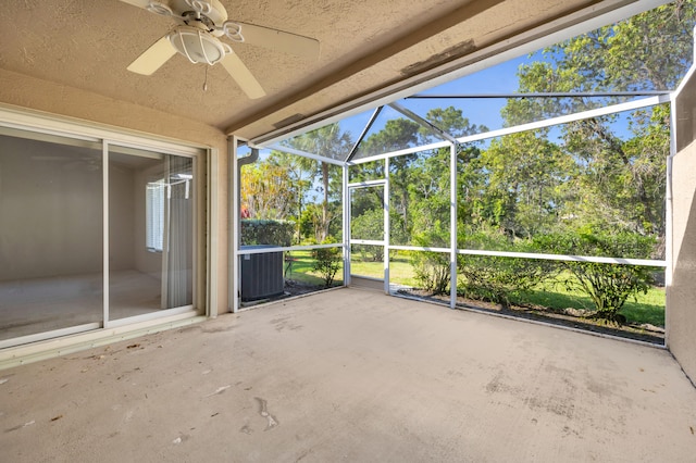 unfurnished sunroom featuring a ceiling fan