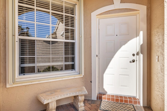 doorway to property with stucco siding