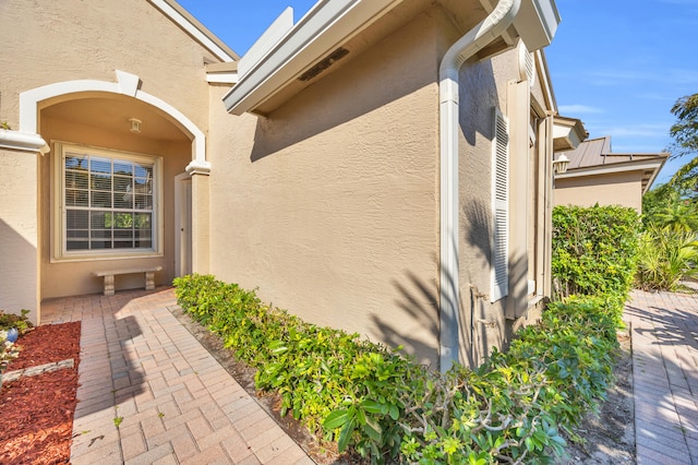 doorway to property with stucco siding