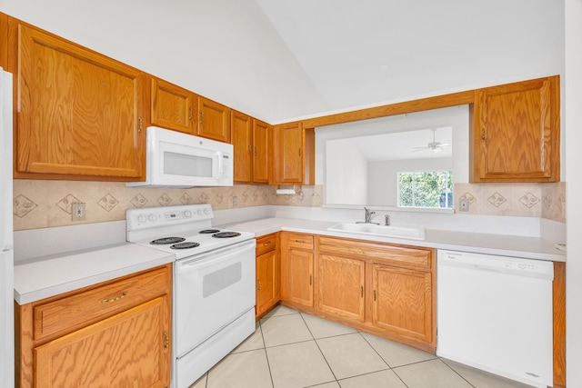 kitchen featuring white appliances, a sink, light countertops, tasteful backsplash, and light tile patterned flooring