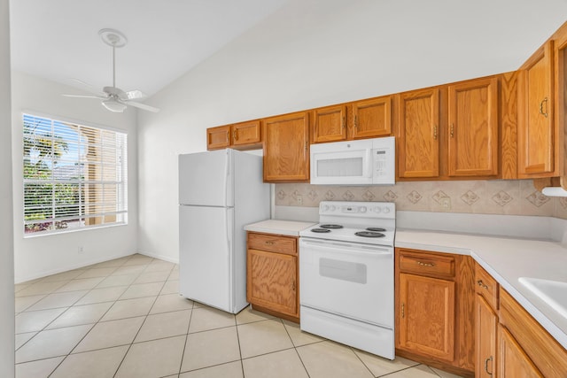 kitchen with white appliances, vaulted ceiling, light countertops, a ceiling fan, and tasteful backsplash