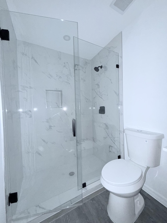 382 Mcarthur Blvd, Lehigh Acres, FL 33974 - full bathroom with toilet, a marble finish shower, wood finished floors, and baseboards