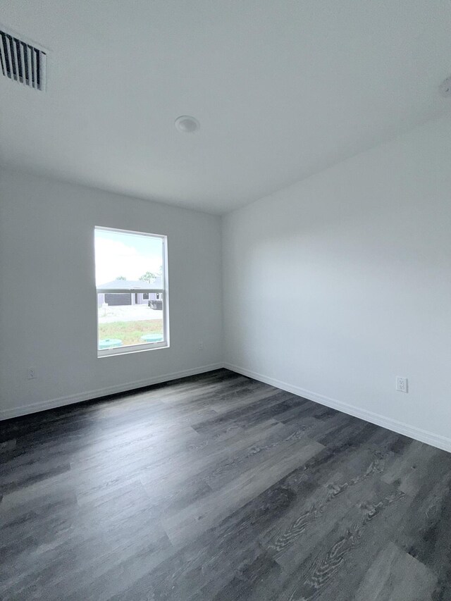 382 Mcarthur Blvd, Lehigh Acres, FL 33974 - unfurnished room with dark wood-style flooring and baseboards