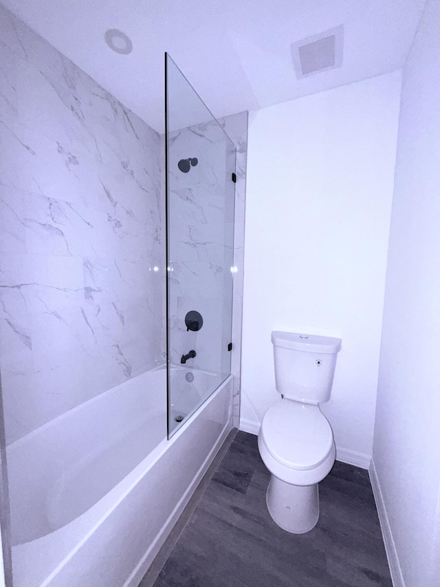 382 Mcarthur Blvd, Lehigh Acres, FL 33974 - full bath featuring toilet, wood finished floors, baseboards, and shower / tub combination
