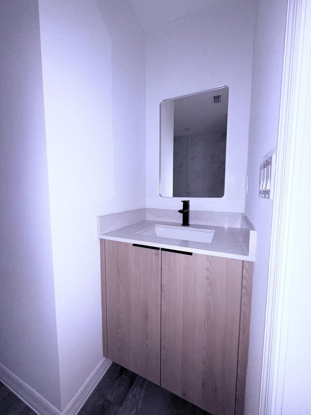 382 Mcarthur Blvd, Lehigh Acres, FL 33974 - bathroom featuring vanity, wood finished floors, and baseboards