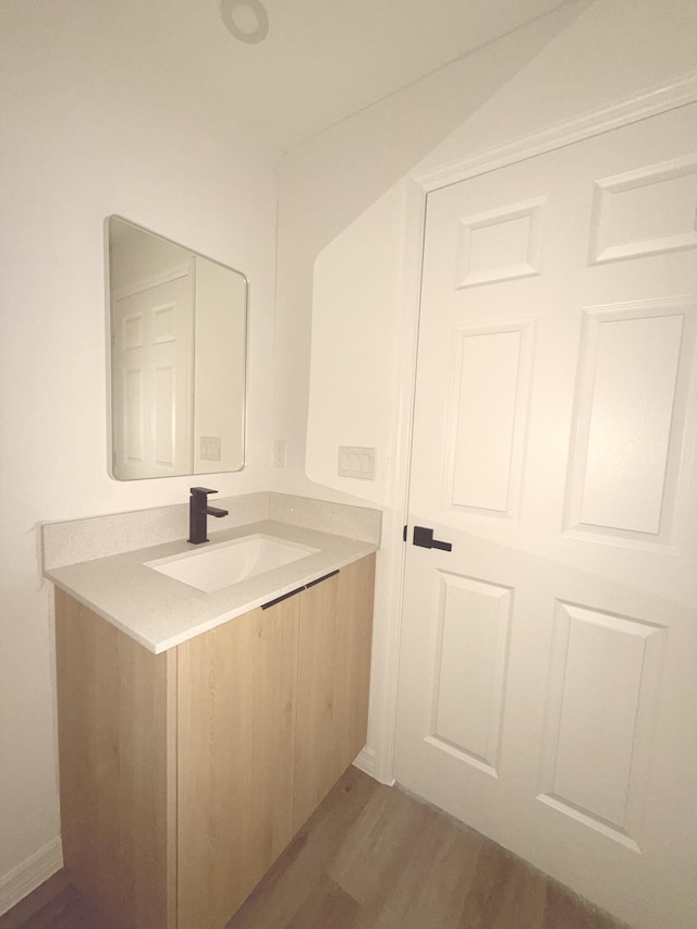 382 Mcarthur Blvd, Lehigh Acres, FL 33974 - bathroom featuring wood finished floors and vanity