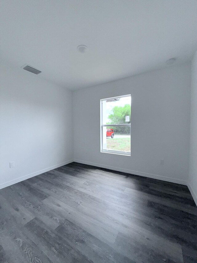 382 Mcarthur Blvd, Lehigh Acres, FL 33974 - empty room featuring dark wood-type flooring and baseboards