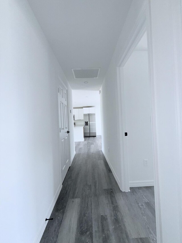 382 Mcarthur Blvd, Lehigh Acres, FL 33974 - corridor featuring dark wood finished floors, attic access, and baseboards