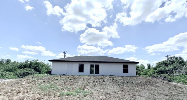 382 Mcarthur Blvd, Lehigh Acres, FL 33974 - back of house featuring stucco siding