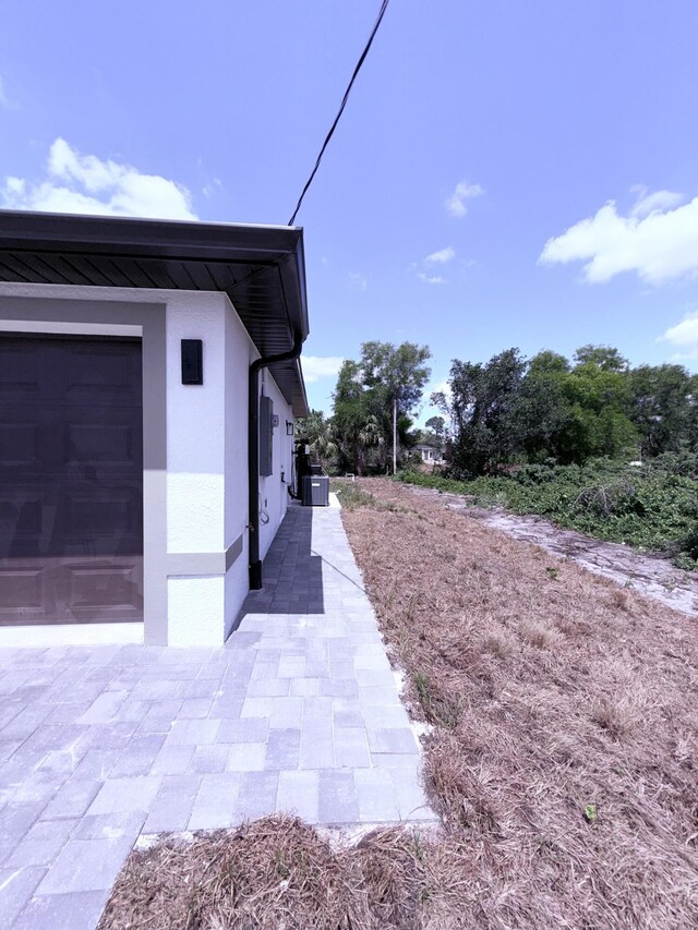 382 Mcarthur Blvd, Lehigh Acres, FL 33974 - view of side of home with stucco siding