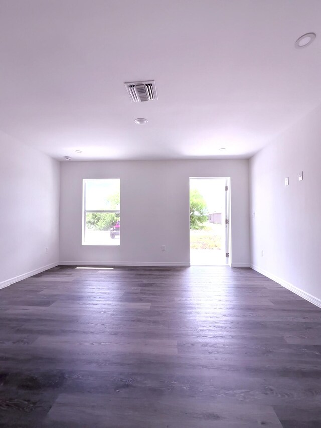 382 Mcarthur Blvd, Lehigh Acres, FL 33974 - unfurnished room with healthy amount of natural light, dark wood-style floors, and baseboards
