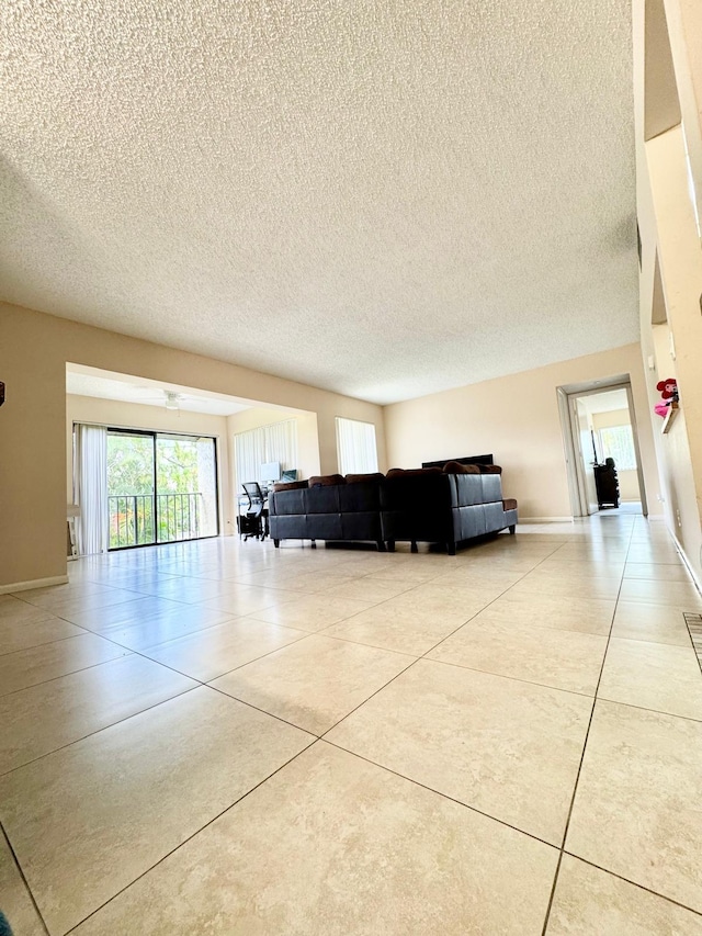 living room featuring a textured ceiling and baseboards