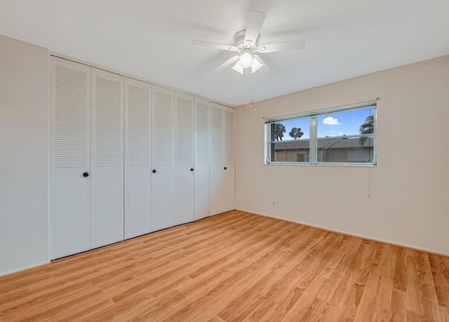 unfurnished bedroom with light wood-type flooring and ceiling fan