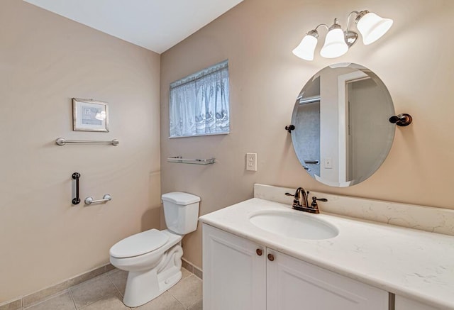 bathroom featuring baseboards, toilet, vanity, and tile patterned flooring