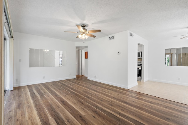 12416 Alternate A1A P7, Palm Beach Gardens, FL 33410 - spare room featuring ceiling fan, a textured ceiling, wood finished floors, and baseboards