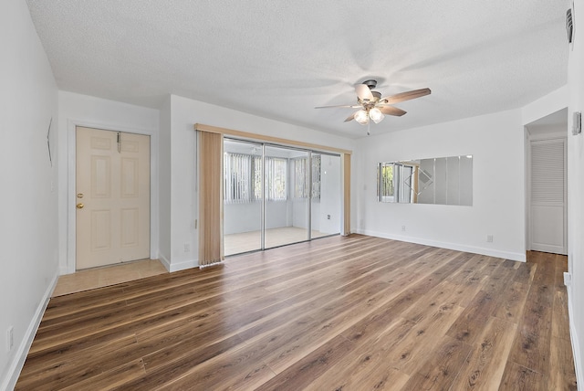 12416 Alternate A1A P7, Palm Beach Gardens, FL 33410 - unfurnished bedroom with wood finished floors, a textured ceiling, baseboards, and a ceiling fan
