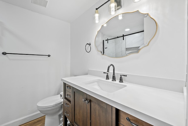 12416 Alternate A1A P7, Palm Beach Gardens, FL 33410 - bathroom featuring wood finished floors, a shower stall, toilet, vanity, and baseboards