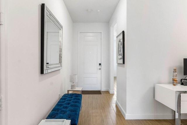 7030 Peters Ln, Delray Beach, FL 33446 - hallway featuring light wood finished floors and baseboards