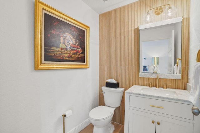 138 NW Magnolia Lakes Blvd, Port Saint Lucie, FL 34986 - half bath with toilet, vanity, baseboards, and wood finished floors
